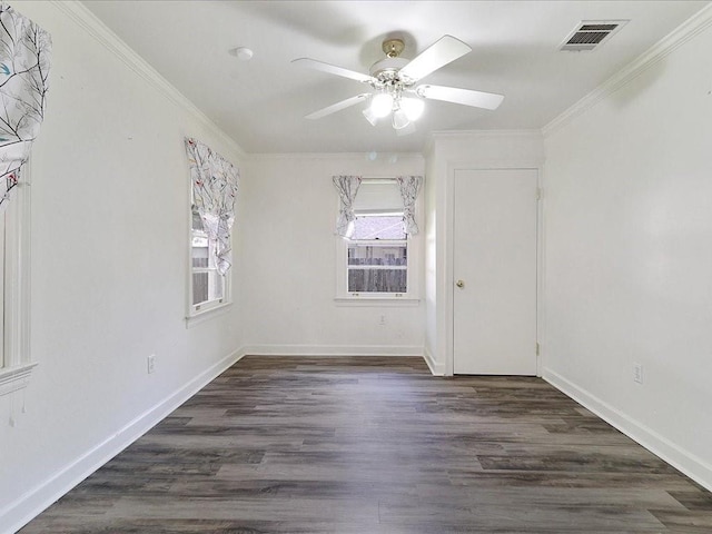 empty room with ceiling fan, dark hardwood / wood-style flooring, and crown molding