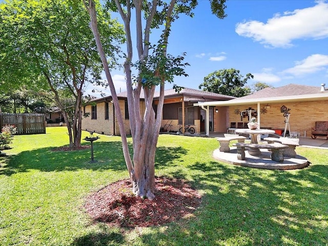 back of property with a patio area and a lawn