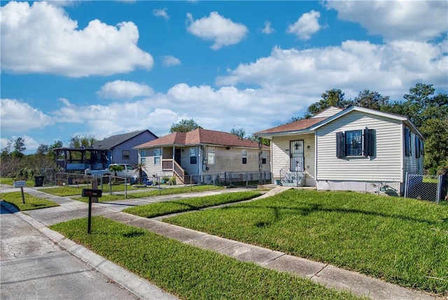 bungalow-style home with a front lawn