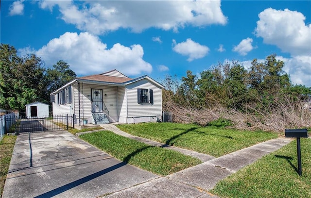 bungalow featuring an outbuilding, a front yard, and a garage