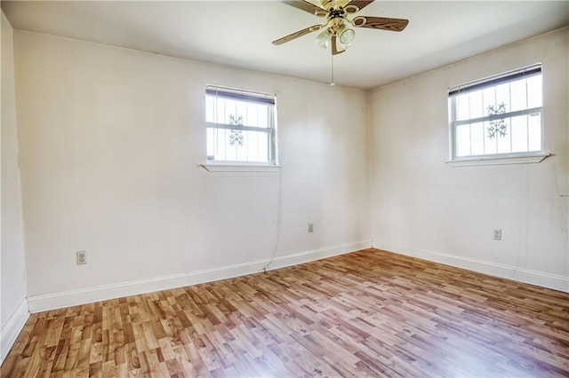 unfurnished room with ceiling fan, a healthy amount of sunlight, and light wood-type flooring