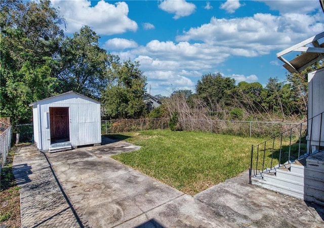 view of yard featuring a storage unit and a patio