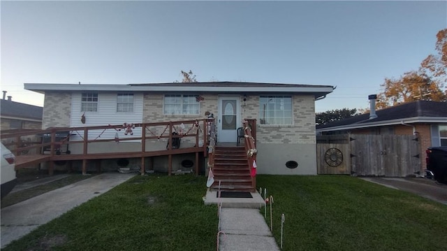 view of front facade with a front yard and a deck