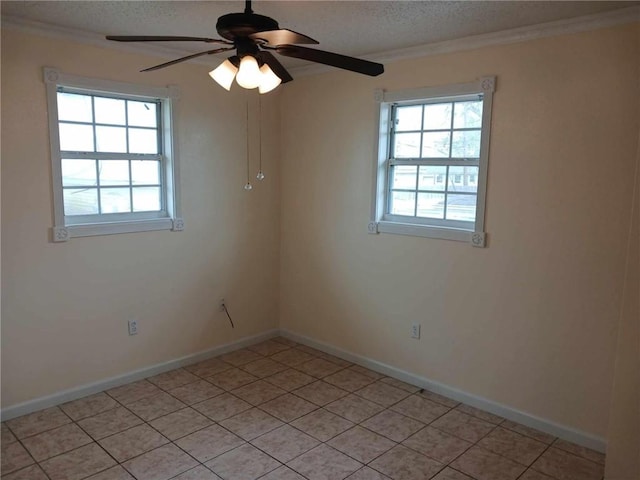 tiled empty room with ceiling fan, a healthy amount of sunlight, and crown molding