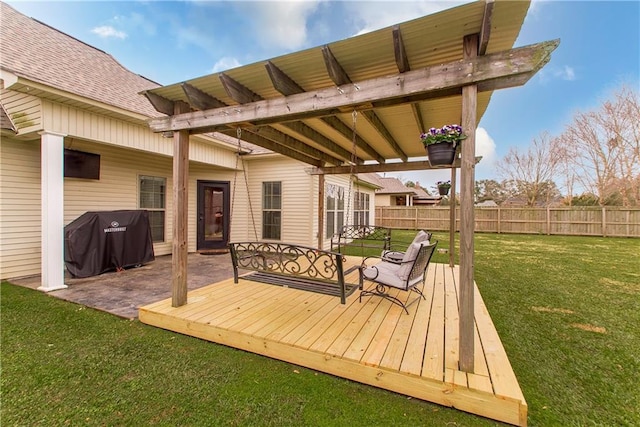 deck featuring a grill and a yard