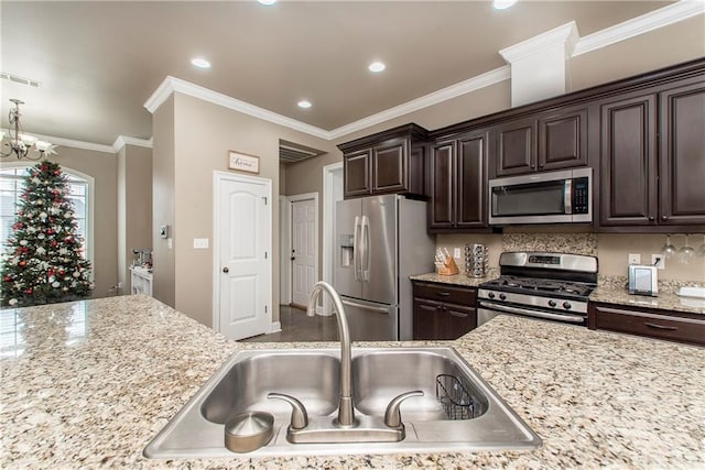 kitchen with dark brown cabinetry, sink, stainless steel appliances, and ornamental molding