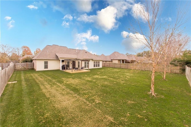 back of property featuring a lawn and a patio area