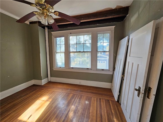 unfurnished room with ceiling fan, dark hardwood / wood-style flooring, and crown molding