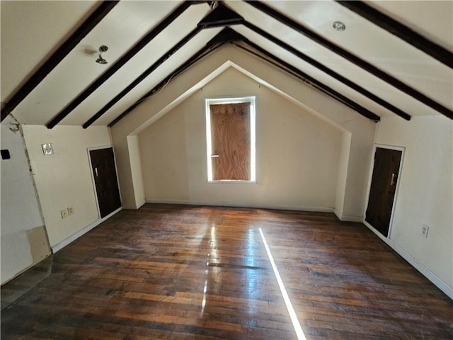 additional living space featuring dark hardwood / wood-style flooring and vaulted ceiling with beams