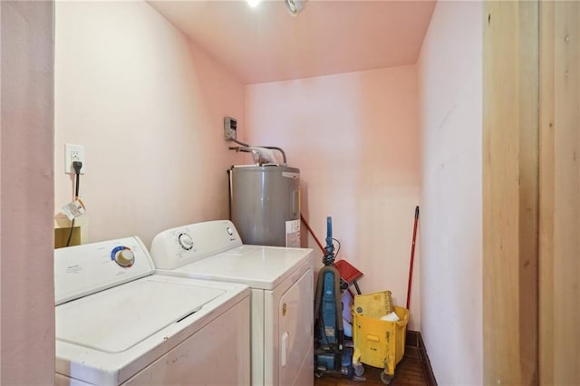 laundry room featuring dark hardwood / wood-style floors, washing machine and dryer, and water heater