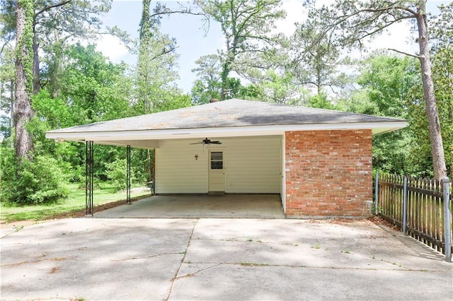 108 N Dr, Covington, LA 70433 - garage with driveway, fence, and a ceiling fan
