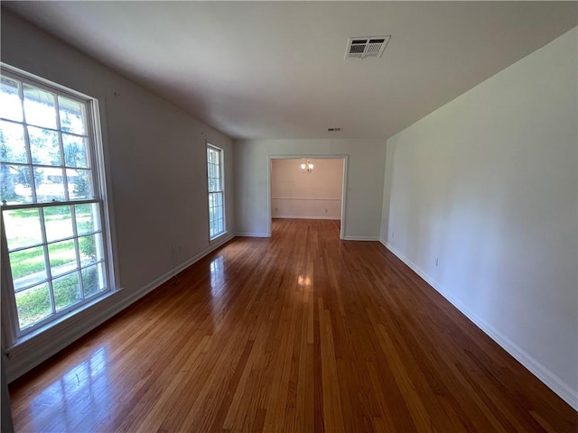 108 N Dr, Covington, LA 70433 - empty room with a chandelier, plenty of natural light, wood finished floors, and baseboards