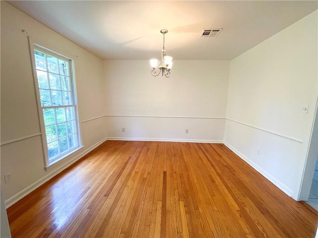 108 N Dr, Covington, LA 70433 - spare room with a chandelier, light wood finished floors, and baseboards