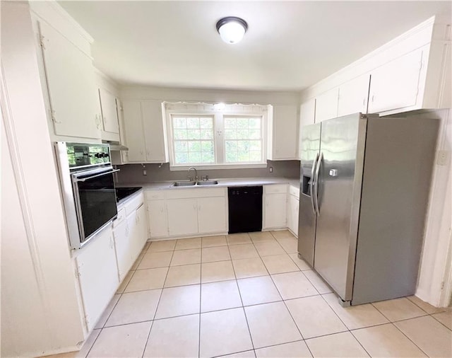 108 N Dr, Covington, LA 70433 - kitchen featuring black appliances, a sink, light tile patterned floors, and white cabinetry
