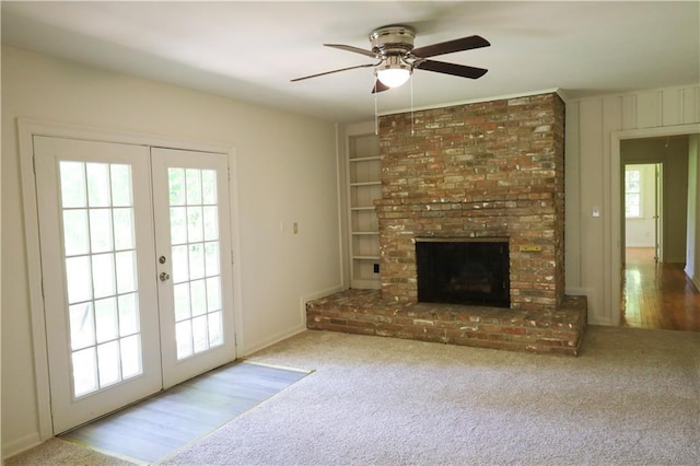 108 N Dr, Covington, LA 70433 - unfurnished living room featuring french doors, ceiling fan, carpet flooring, and a fireplace