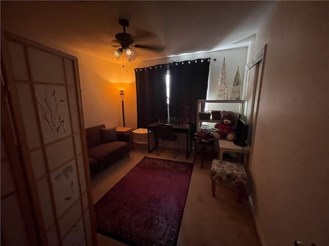 interior space featuring ceiling fan and carpet