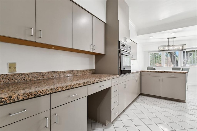 kitchen featuring dark stone countertops, kitchen peninsula, oven, decorative light fixtures, and light tile patterned floors