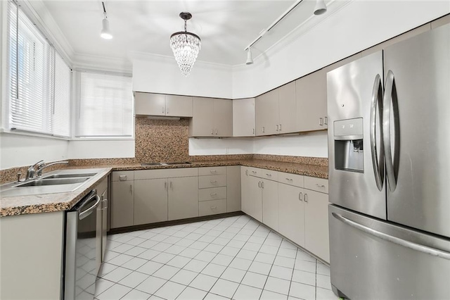 kitchen with rail lighting, stainless steel appliances, crown molding, sink, and pendant lighting