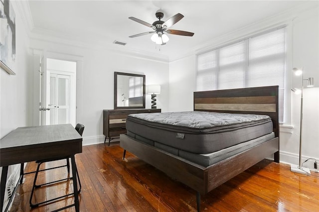 bedroom with dark hardwood / wood-style flooring, ceiling fan, and crown molding