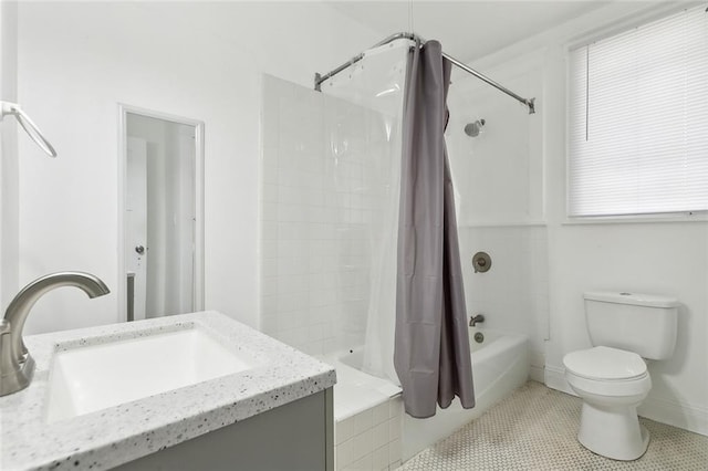 full bathroom with vanity, shower / tub combo with curtain, a healthy amount of sunlight, tile patterned flooring, and toilet