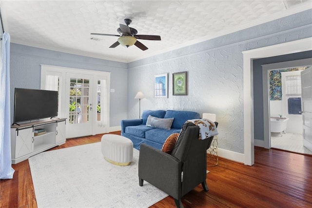 living room featuring ceiling fan, ornamental molding, and hardwood / wood-style flooring