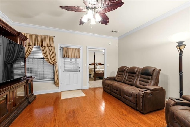 living room with ceiling fan, light hardwood / wood-style flooring, and ornamental molding