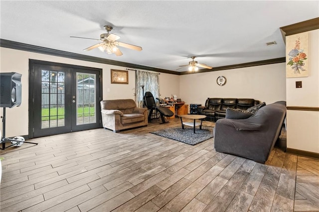 living room with ceiling fan, french doors, hardwood / wood-style floors, and ornamental molding