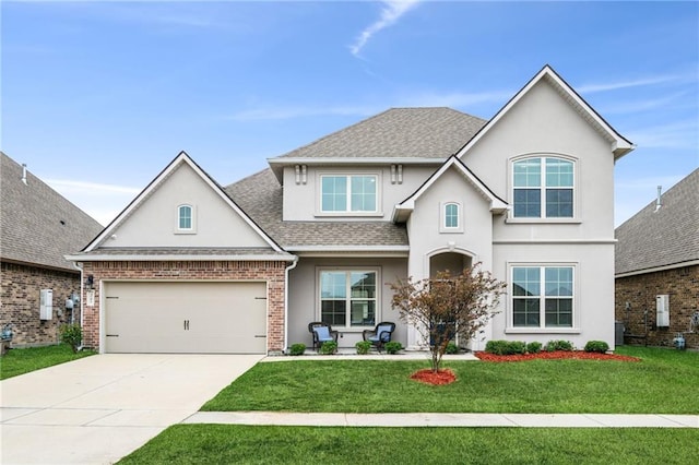 view of front of property with a garage and a front lawn