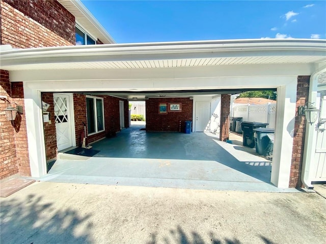 garage featuring an attached carport and driveway