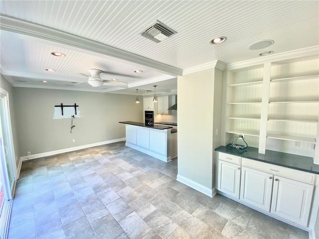 kitchen with visible vents, baseboards, dark countertops, and wall chimney range hood