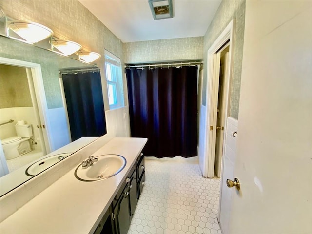 full bath featuring toilet, curtained shower, tile walls, tile patterned flooring, and vanity