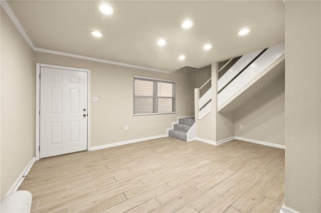 basement featuring ornamental molding and light wood-type flooring