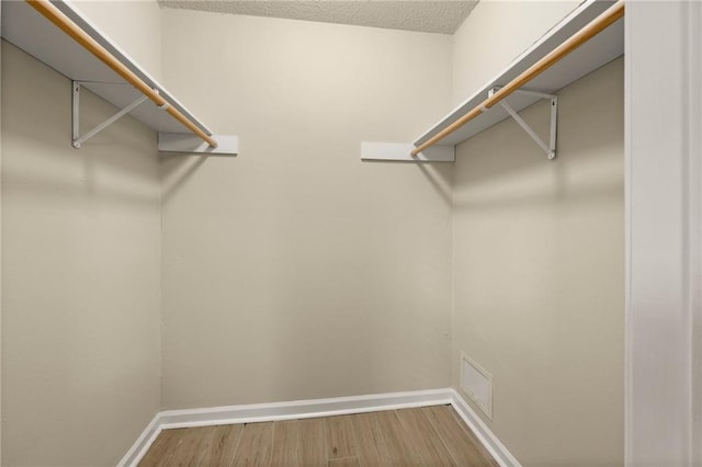 walk in closet featuring wood-type flooring