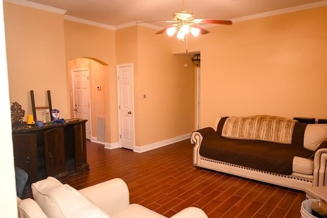 living room with dark hardwood / wood-style floors, ceiling fan, and crown molding