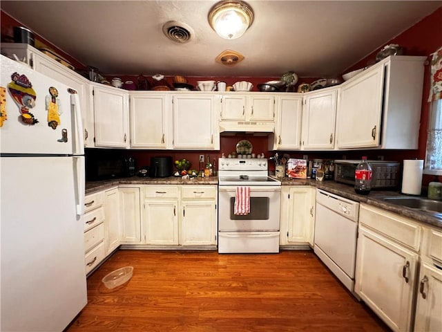 kitchen featuring light wood-type flooring, white appliances, and sink