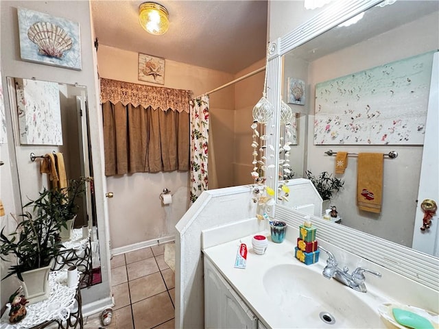 bathroom with tile patterned floors, vanity, and walk in shower