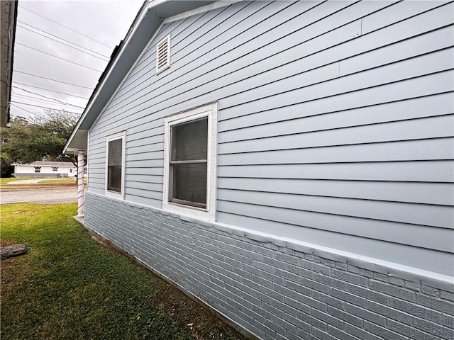 view of property exterior with a lawn