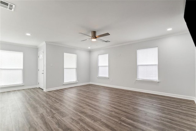 unfurnished room with crown molding, ceiling fan, and dark wood-type flooring