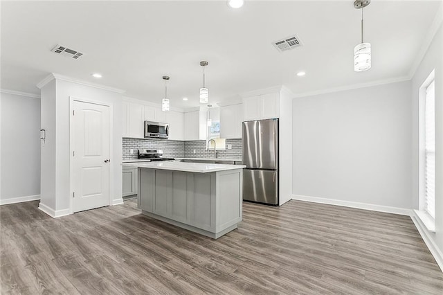 kitchen featuring plenty of natural light, a kitchen island, and stainless steel appliances