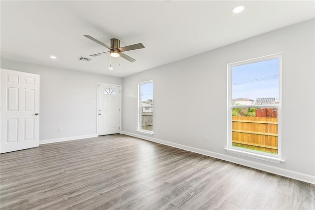 unfurnished room with hardwood / wood-style floors and ceiling fan