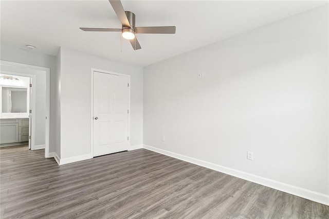 unfurnished bedroom featuring ceiling fan and dark hardwood / wood-style floors