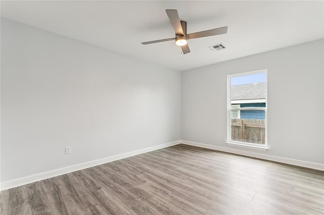 empty room with ceiling fan and light hardwood / wood-style floors