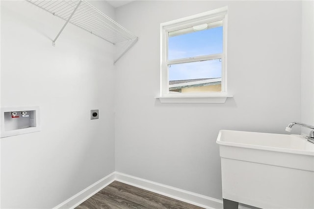 washroom featuring hookup for a washing machine, dark hardwood / wood-style flooring, electric dryer hookup, and sink