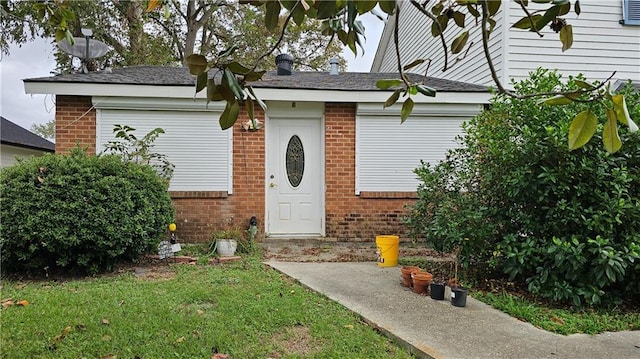 entrance to property with a yard