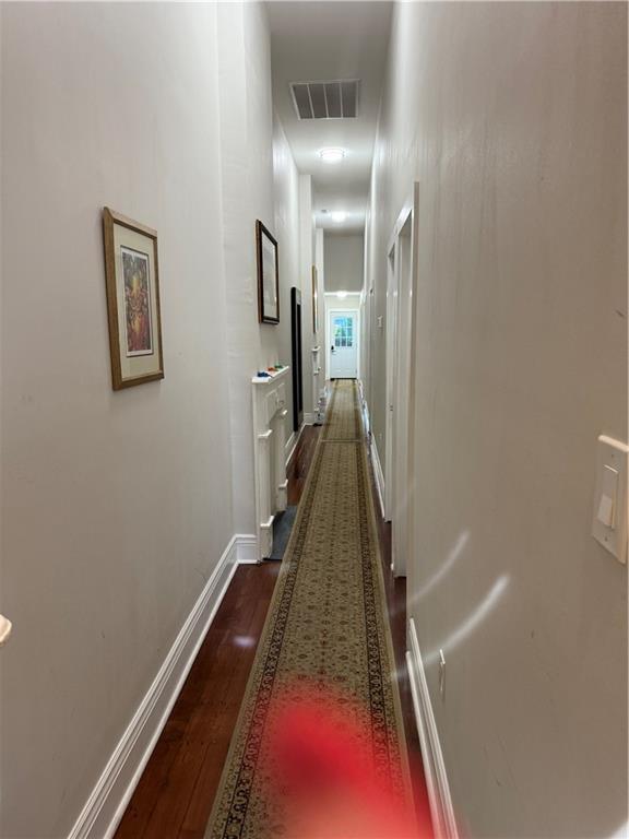 hallway featuring dark hardwood / wood-style flooring