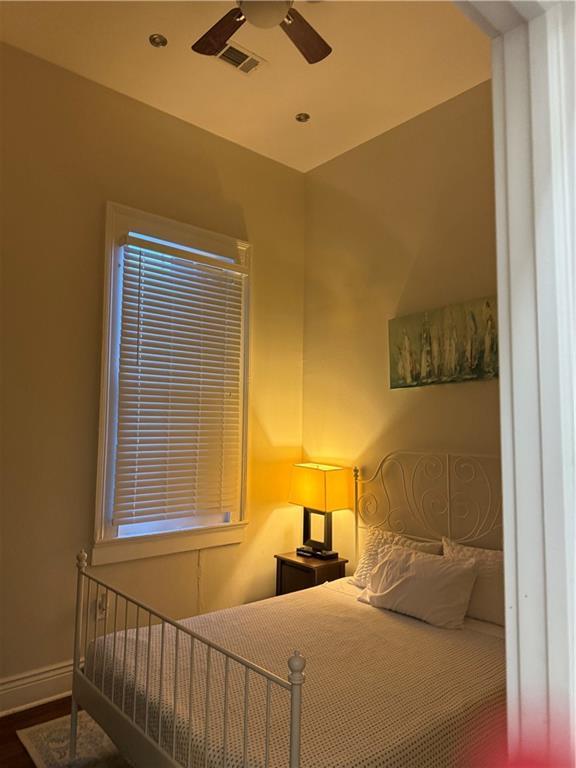 bedroom featuring ceiling fan and hardwood / wood-style floors