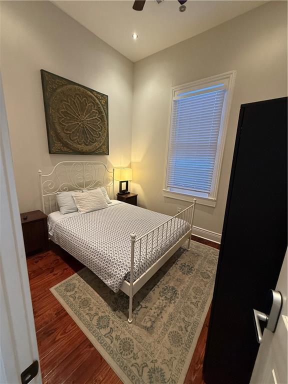 bedroom featuring ceiling fan and wood-type flooring