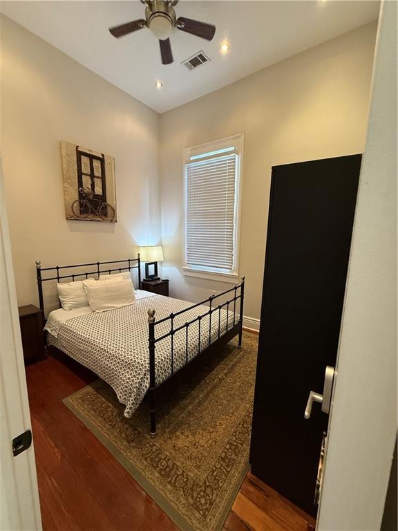 bedroom featuring dark hardwood / wood-style floors and ceiling fan