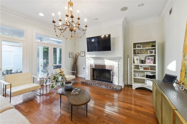 living room with hardwood / wood-style floors, crown molding, and a fireplace