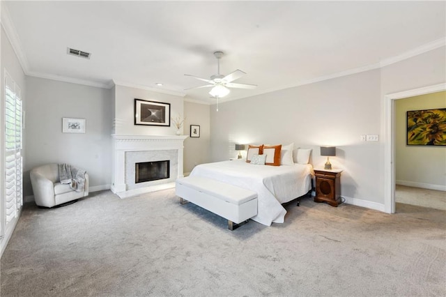 carpeted bedroom with ceiling fan and crown molding